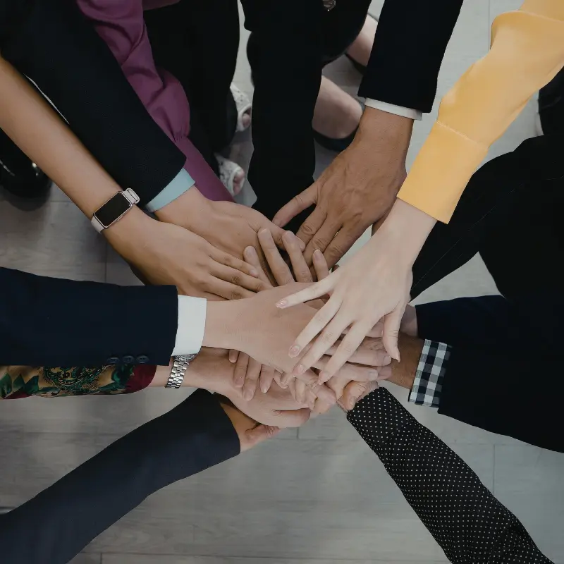 Several professionals put their hands together.